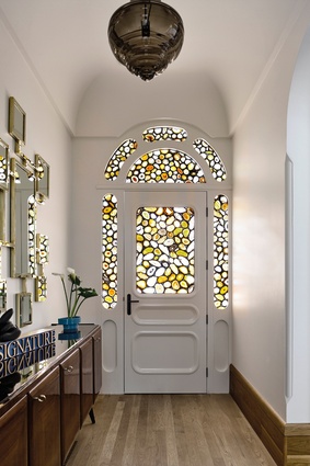 While the arched front door may not be historically accurate, it fits seamlessly in the house. The agate leadlight panels were inspired by the work of Sigmar Polke, a German artist.