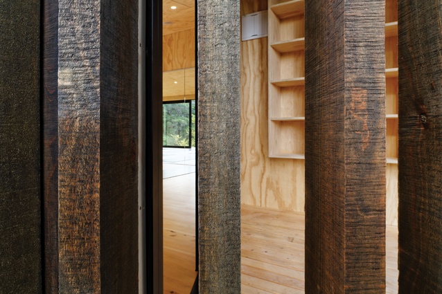 Stained timber battens cast shadows and negotiate the transition between inside and outside. 